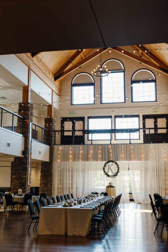 A wedding reception hall with string lights throughout 