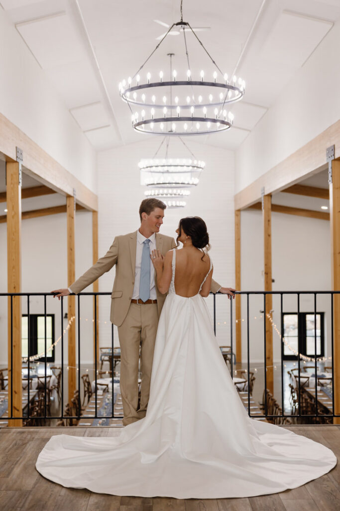 Newlyweds standing close together smiling on their wedding day 