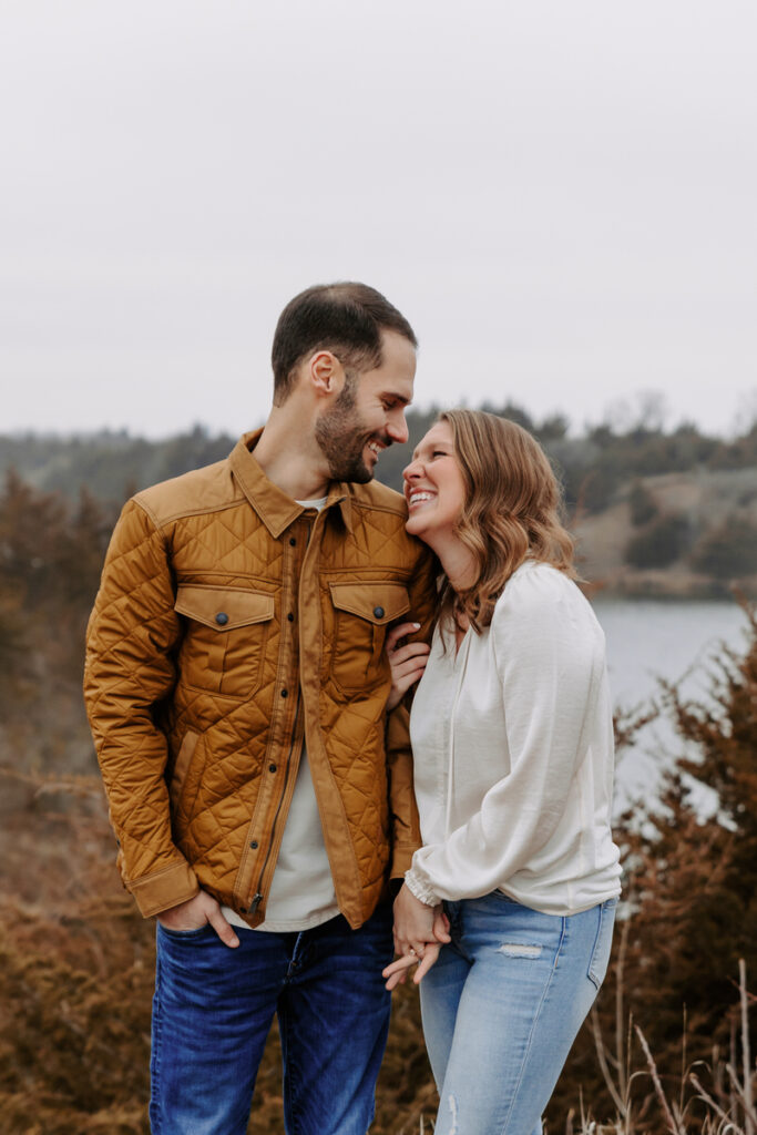 A person with their arm wrapped around their partner's as they smile at each other