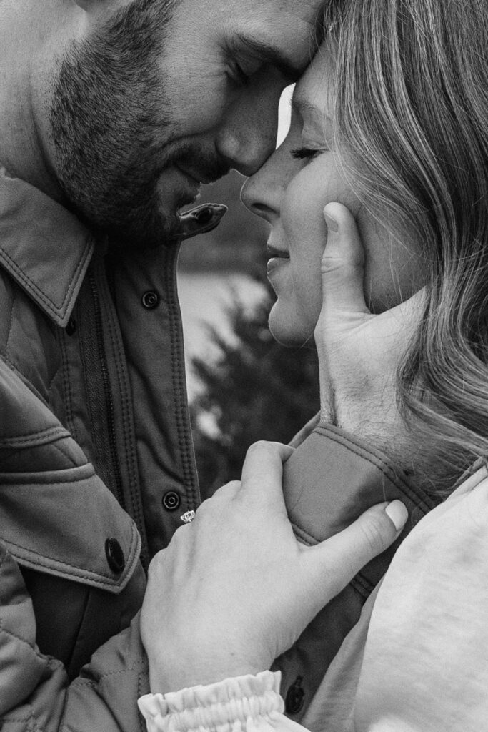 A close up of a couple with their foreheads touching and eyes closed. 