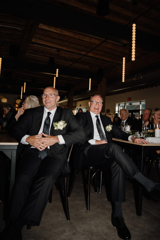 Wedding guests sitting and laughing together 