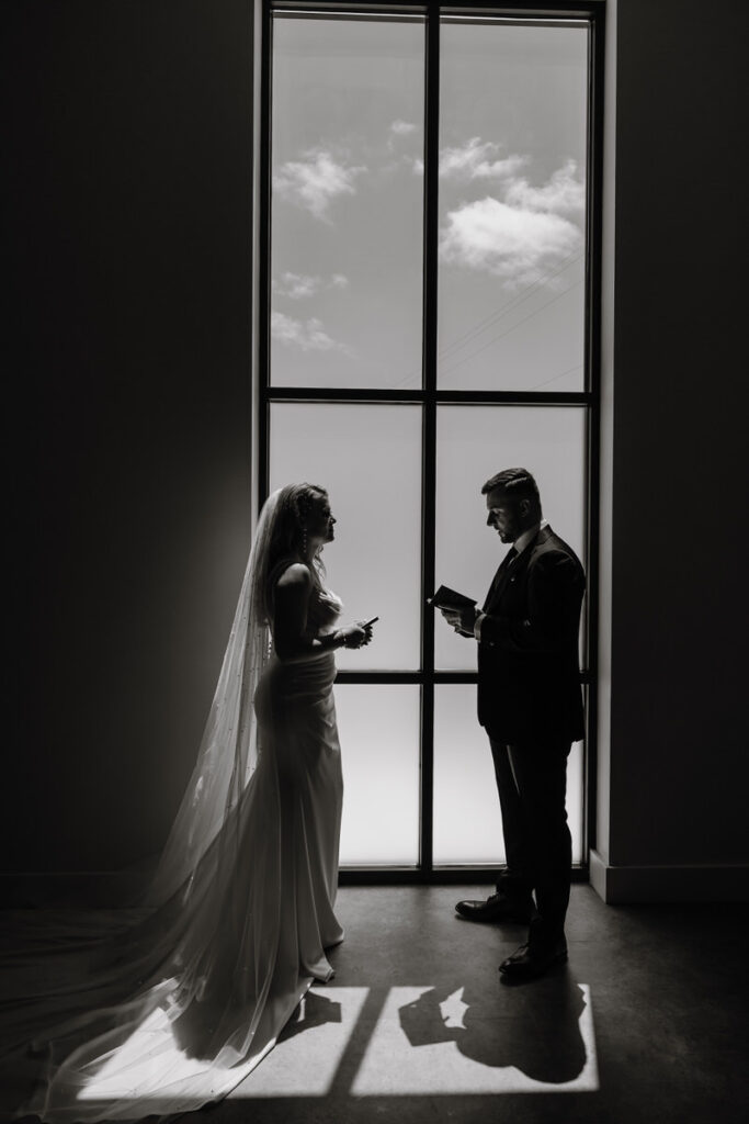 Newlyweds reading notes from small notebooks
